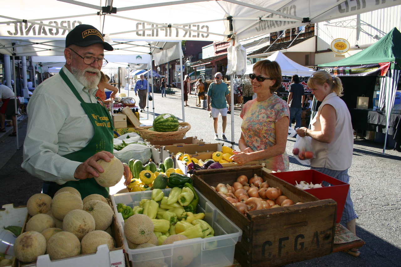 Person selling fruits and vegetables at Farmer's Market in Nevada County