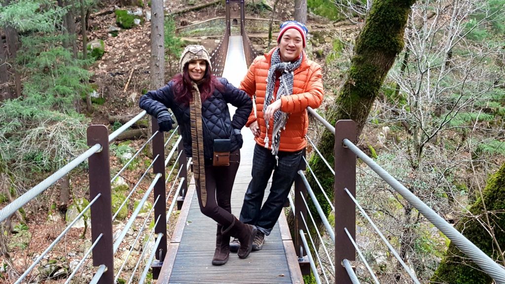 a man and woman on Deer Creek Suspension Bridge in Nevada City during the fall