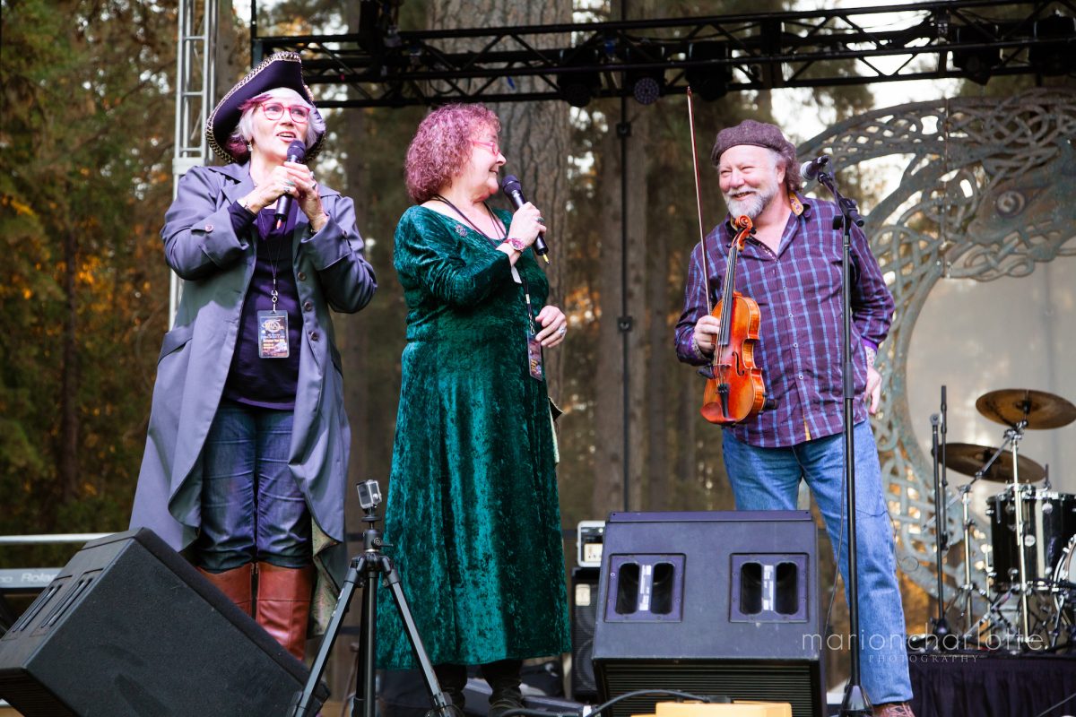 Two musicians and speaker on the stage at the 2016 Celtic Festival