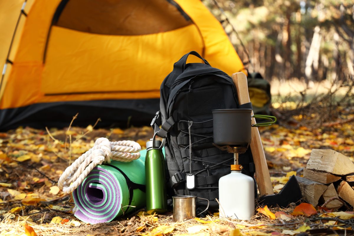 backpack and camping gear in front of the tent