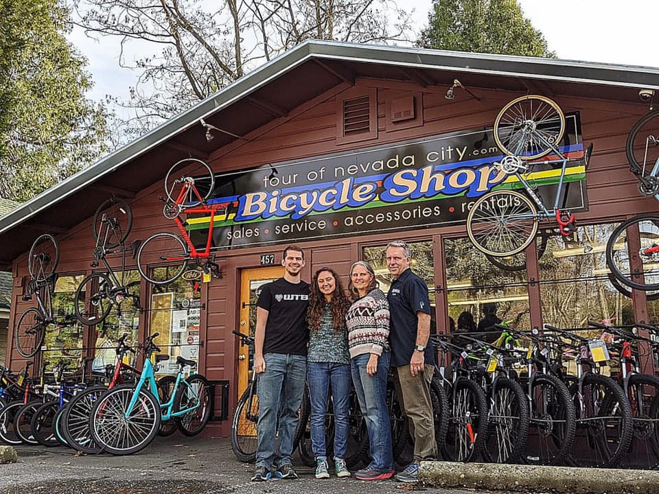 exterior of Tour of Nevada City Bicycle Shop with owners in front