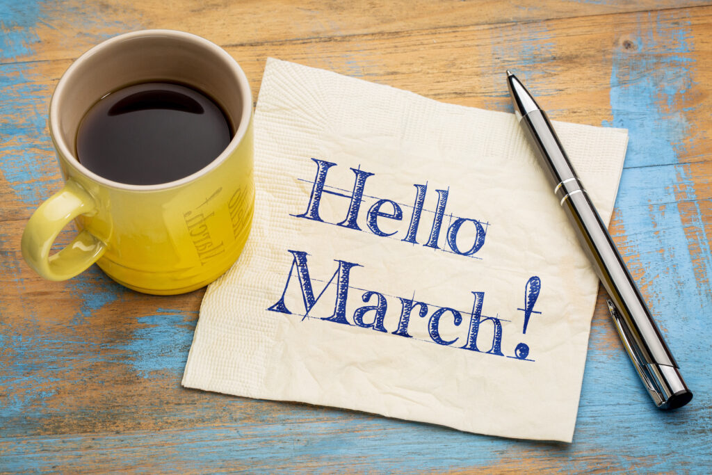 Hello March - handwriting on a napkin with a cup of coffee