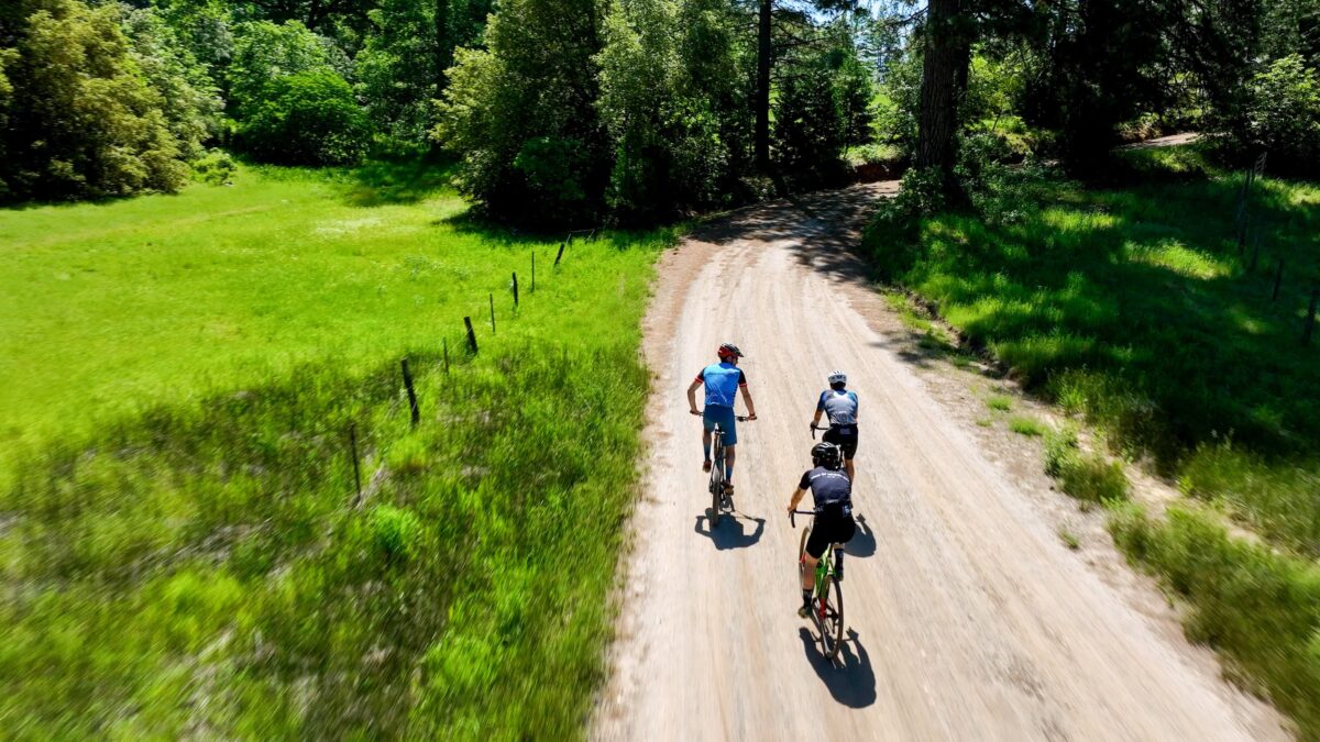 3 cyclists enjoying a gravel road in the foothills of the Sierra