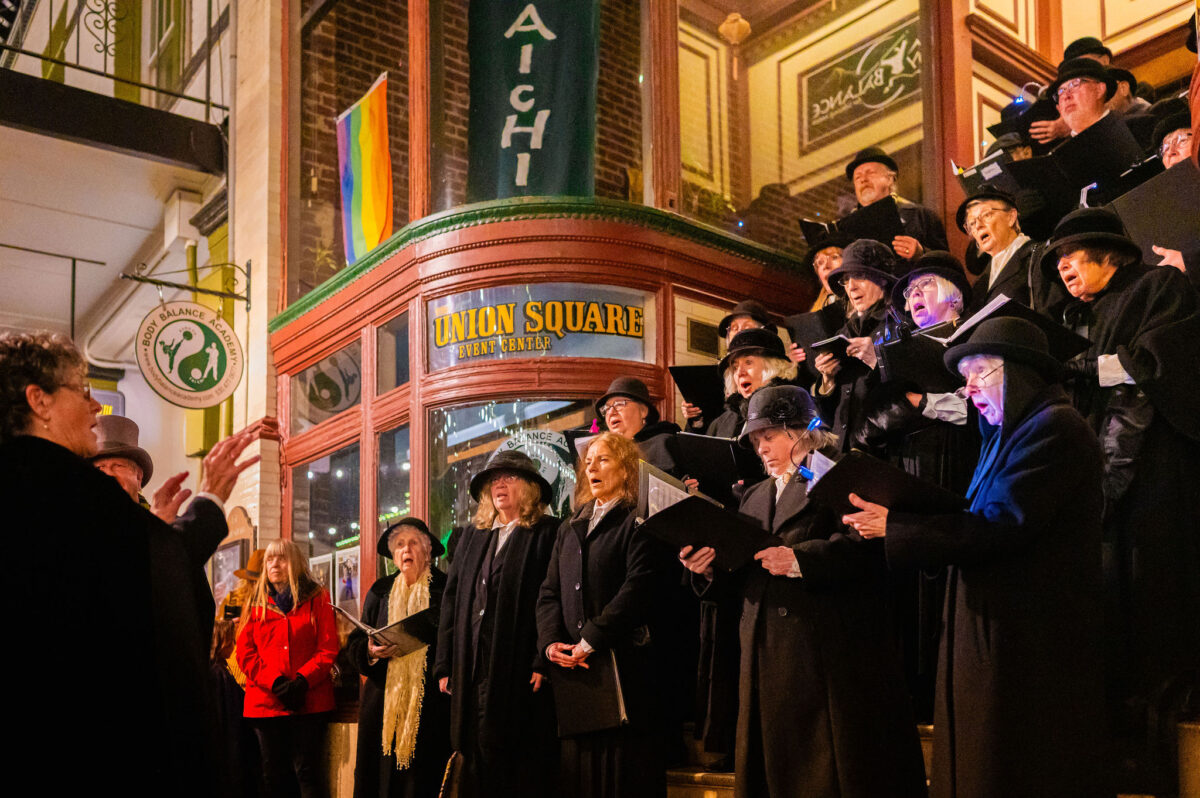 Carolers singing in front of the Union at Cornish Christmas in Grass Valley