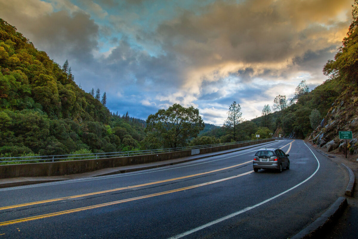 car driving on Highway 49 on a scenic stretch of the South Yuba River