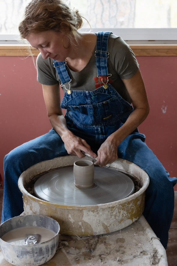 woman working on pottery at Pickle Pottery