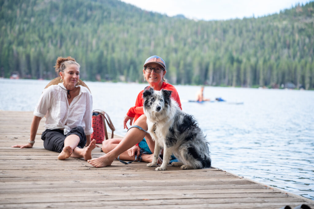 Two women and a dog hanging out on the Donner Public Piers