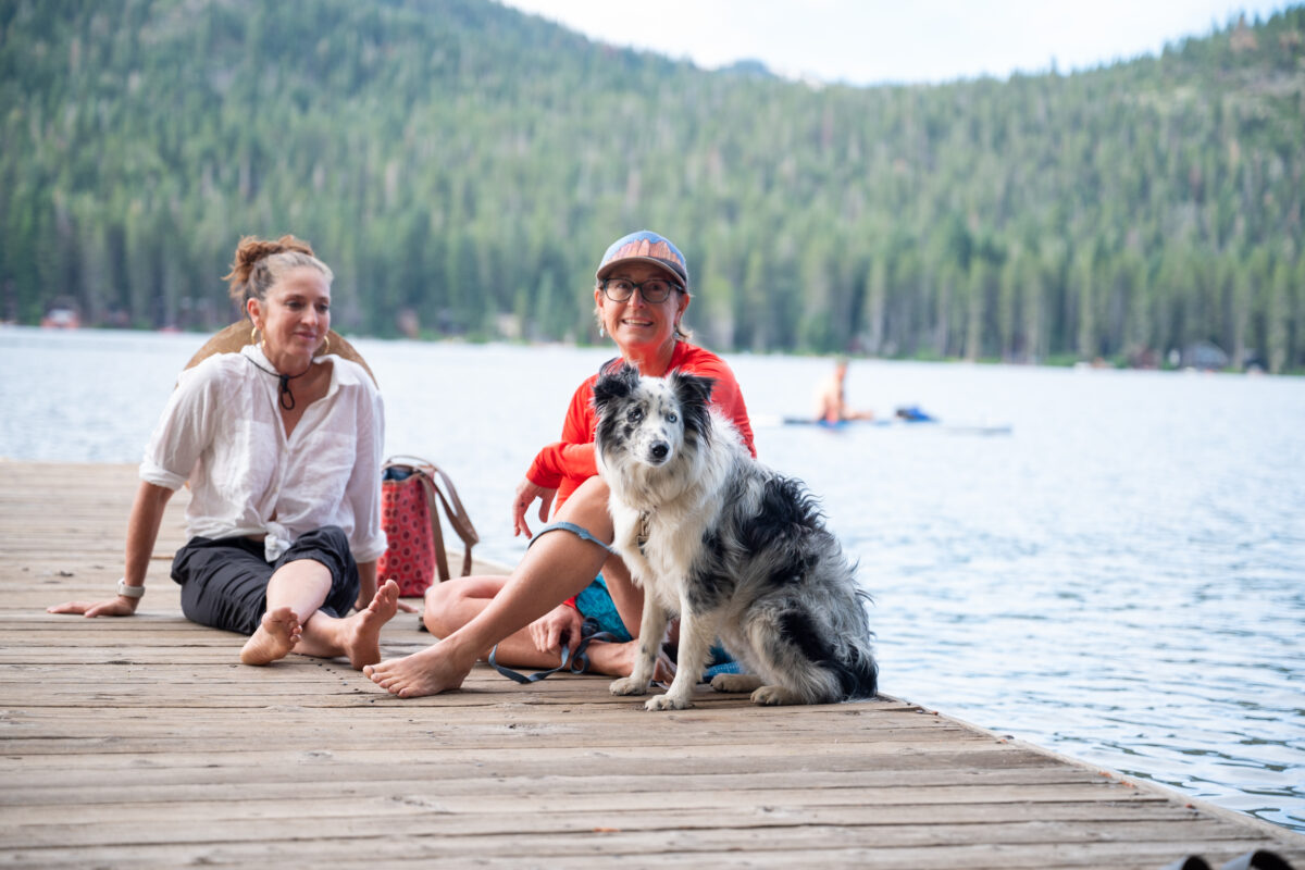 Two women and a dog hanging out on the Donner Public Piers